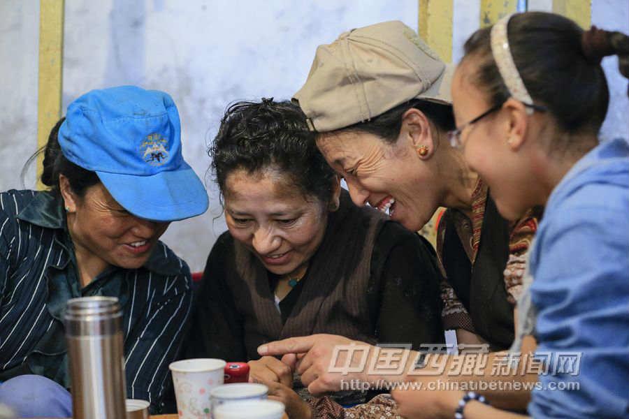 大人忙不過(guò)來(lái)的時(shí)候，就把錢(qián)給孩子們?nèi)ベI(mǎi)甜茶，然后大家休息一會(huì)兒，喝茶，吃餅子。巴桑拉姆（右）跟大人們坐在一起，大家在看手機(jī)上的圖片。